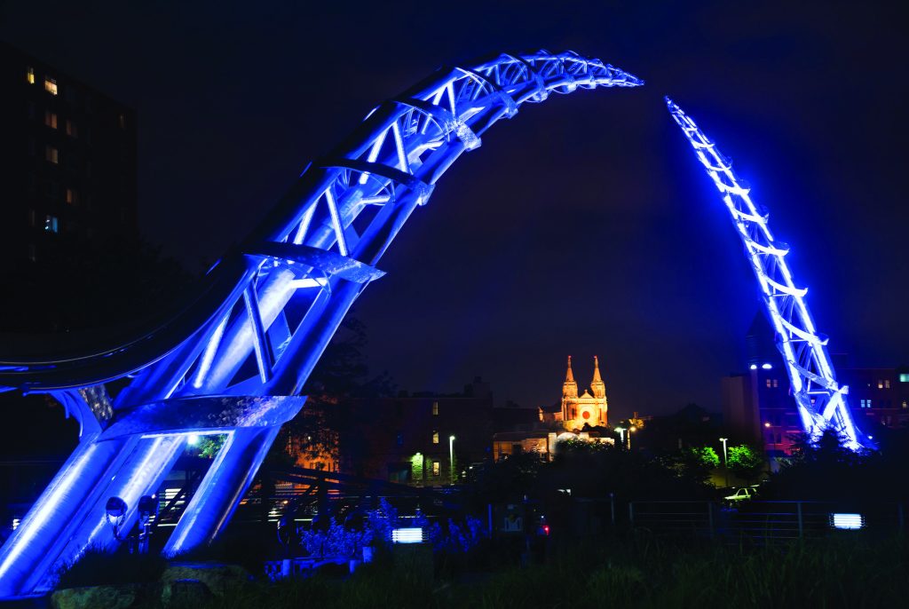 The Arc of Dreams, a monumental stainless-steel sculpture spanning the Big Sioux River