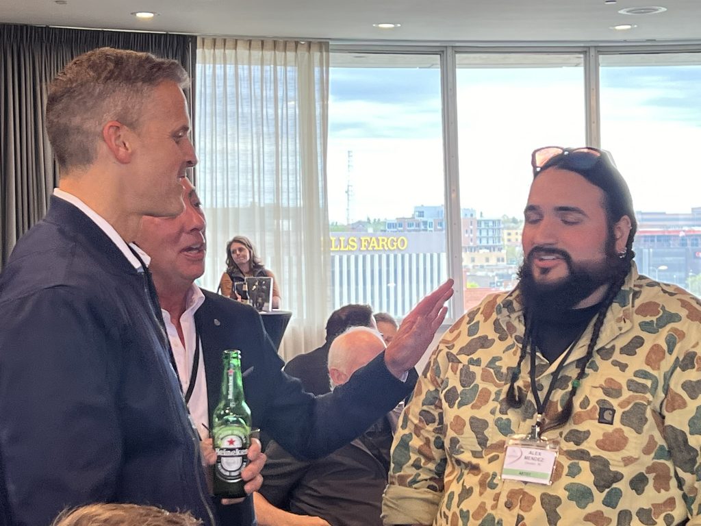 Mayor Paul TenHaken talks to artist Alex Mendez